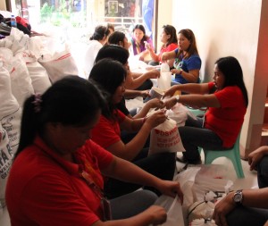 Staff of DSWD Field Office VII repack relief goods for distribution to victims of 'Yolanda'.