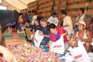 DSWD Secretary Corazon Juliano-Solimanjoins the repacking of relief goods at the DSWD hub inTacloban. Photo by DSWD