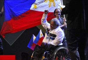 A jubilant Julius Rosalinda, with the Philippine flag in the background, after winning the silver medal in the Waste Re-Use competition during the 9th Abilympics held in March in Bordeaux, France.