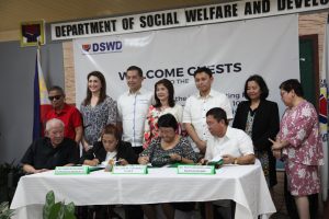 DSWD Secretary Judy M. Taguiwalo (3rd from left) , Department of Health (DOH) Undersecretary Gerardo Bayugo (right), and National Council on Disability Affairs (NCDA) Dir. Carmen Zubiaga (2nd from left) sign the Implementing Rules and Regulations of Republic Act 1075 or an Act Expanding the Benefits and Privileges of Persons with Disability. Witnessing the signing are principal authors of the law, Rep. Martin Romualdez (3rd from left) and Sen. Sonny Angara (3rd from right), Cong. Yedda Romualdez (2nd from left), Rep. Imelda Calixto-Rubiano (center), DSWD Undersecretary Florita Villar, and representatives of the PWD sector.