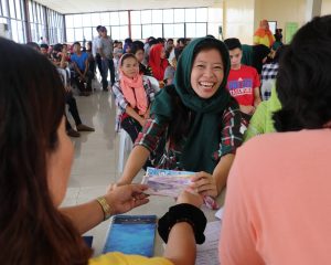 A Marawi siege-evacuee beams as she receives her cash assistance in exchange of work that she rendered under the Department of Social Welfare and Development's (DSWD) Cash-for-Work (CFW) program. 