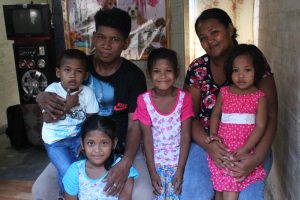 Former street dweller Arlene Ramirez and her family inside their new house in Brgy. Kalunasan, Cebu City.
