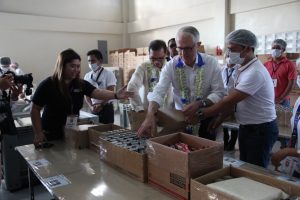 Australian Prime Minister Malcolm Turnbull (2nd from right)  and  Department of Social Welfare and Development (DSWD) Officer-in-Charge (OIC) Emmanuel A. Leyco (2nd from left) beam as they fill empty family food pack boxes with relief supplies during the Prime Minister's visit at the DSWD National Resource Operations Center (NROC) on November 13, 2017 in Pasay City.