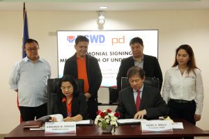 Department of Social Welfare and Development Secretary Virginia N. Orogo (seated, left) and Philippine Disaster Resilience Foundation, Inc. President Rene S. Meily (seated, right) signing the Memorandum of Understanding (MOU) for a partnership on disaster response operations. Also in photo are (standing from left to right): DSWD-National Response and Logistics Management Service (NRLMS) Director Fernando R. De Villa, Jr; DSWD OIC-Undersecretary for General Administration and Support Services Group Rodolfo Santos; PDRF Operations Director Felino C. Castro; and PDRF Executive Director Veronica Gabaldon.
