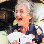 Florentina A. Alagao, a 72-year-old resident of Barangay Malpeg-Patalan, Cuyapo in Nueva Ecija, beams after receiving her emergency cash subsidy under the Social Amelioration Program.