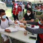 Department of Social Welfare and Development (DSWD) personnel hand over financial assistance to a locally stranded individual during the second batch of the Hatid Tulong Grand Send-Off held on July 25 to 29.