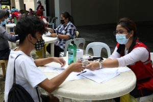 Social workers of the Department of Social Welfare and Development (DSWD) distribute financial aid to locally stranded individuals (LSIs) during the third Hatid Tulong Grand Send-Off at the Cultural Center of the Philippines (CCP) Complex, Pasay City on October 19.