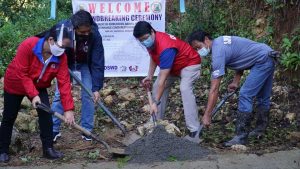Department of Social Welfare and Development (DSWD) Secretary Rolando Joselito D. Bautista (second from right) is joined by Kapangan, Benguet Mayor Manny Fermin; DSWD Kalahi-CIDSS National Program Manager Janet P. Armas; and a Kalahi-CIDSS volunteer during the ground breaking ceremony for the enhancement of the Amburayan-Abiang Access Road.