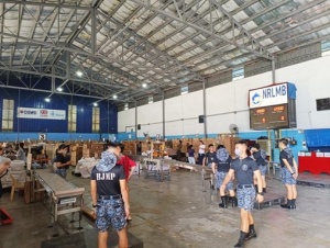 Volunteers from the Bureau of Jail Management and Penology (BJMP) assist in the repacking operations at the National Resource Operations Center (NROC) 