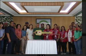 DSWD Undersecretary Vilma B. Cabrera receives the symbolic key from Oriental Mindoro Governor Humerlito Bonz Dolor which marks the turnover of the warehouses and satellite office to the Department. DSWD officials and provincial and municipal local chief executives witness the turnover.