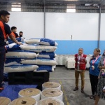 Department of Social Welfare and Development (DSWD) Undersecretary for Disaster Response Management Group Atty. Marco Bautista (in red ves) and United Kingdom Ambassador to the Philippines Laure Beaufils (2nd from foreground) check on the repacking activities at the National Resource Operations Center on Friday, November 18.