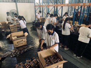 Volunteers from the Church of God International repack coffee sachets for distribution to families affected by Severe Tropical Storm Paeng at the National Resource Operations Center (NROC).