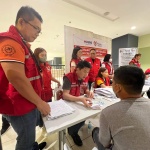Department of Social Welfare and Development (DSWD) Officer-in-Charge (OIC) Eduardo M. Punay (middle) facilitates the provision of financial assistance to a resident affected by the flooding caused by a low pressure area in Sibuco, Zamboanga del Norte on Wednesday, January 25. Also joining OIC Punay during the payout are DSWD Field Office IX Director Riduan P. Hadjimuddin (left), and Assistant Secretaries Arnel Garcia (4th from left) and Diane Cajipe (right).