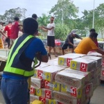 Airline personnel unload boxes of family food packs at the Cebu Pacific Cargo Office in Puerto Princesa City, Palawan.