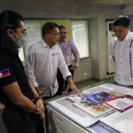 Department of Social Welfare and Development (DSWD) Secretary Rex Gatchalian listens to Philippine Disaster Resilience Foundation (PDRF) Chief Resilience Officer Guillermo Luz as he shows information materials published by the PDRF.