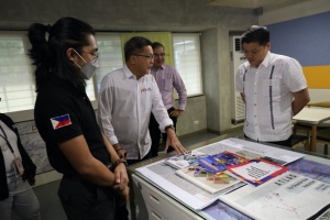 Department of Social Welfare and Development (DSWD) Secretary Rex Gatchalian listens to Philippine Disaster Resilience Foundation (PDRF) Chief Resilience Officer Guillermo Luz as he shows information materials published by the PDRF.