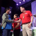 Department of Social Welfare and Development (DSWD) Secretary Rex Gatchalian greets a beneficiary who received financial assistance, under the Assistance to Individuals in Crisis Situation (AICS) program, during a payout activity in Butuan City on Saturday, March 18, 2023.