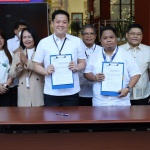 Department of Social Welfare and Development Secretary Rex Gatchalian and Social Welfare Employees’ Association of the Philippines representative Anthony Septimo present the newly-signed administrative orders for the implementation of the grant of each Magna Carta benefit to public social workers and hazard pay for public social welfare and development workers during the Agency’s flag ceremony at the DSWD Central Office on Monday, March 6. Also in photo are DSWD executive and management committee members.