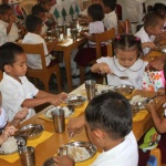 School children enjoy nutritious meal served during a supplementary feeding program