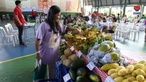 Maricris buys fruits, vegetables and other goods during the Food Stamp Program’s redemption day.